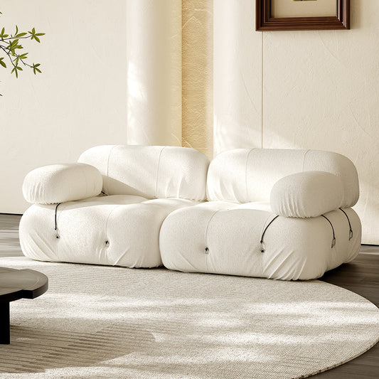 Hiksnra two-seater modular sofa in light cream, with plush cushions and gathered upholstery