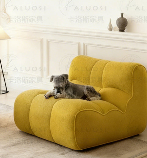 Hippopotamus sofa, amber yellow with curved back and plush rounded seat cushions