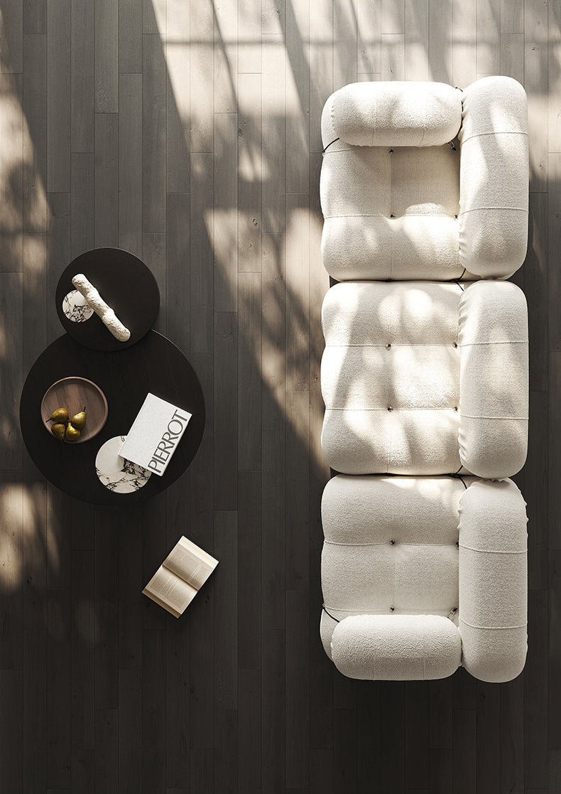 Cream modular sectional sofa with stacked seat sections and rounded headrest