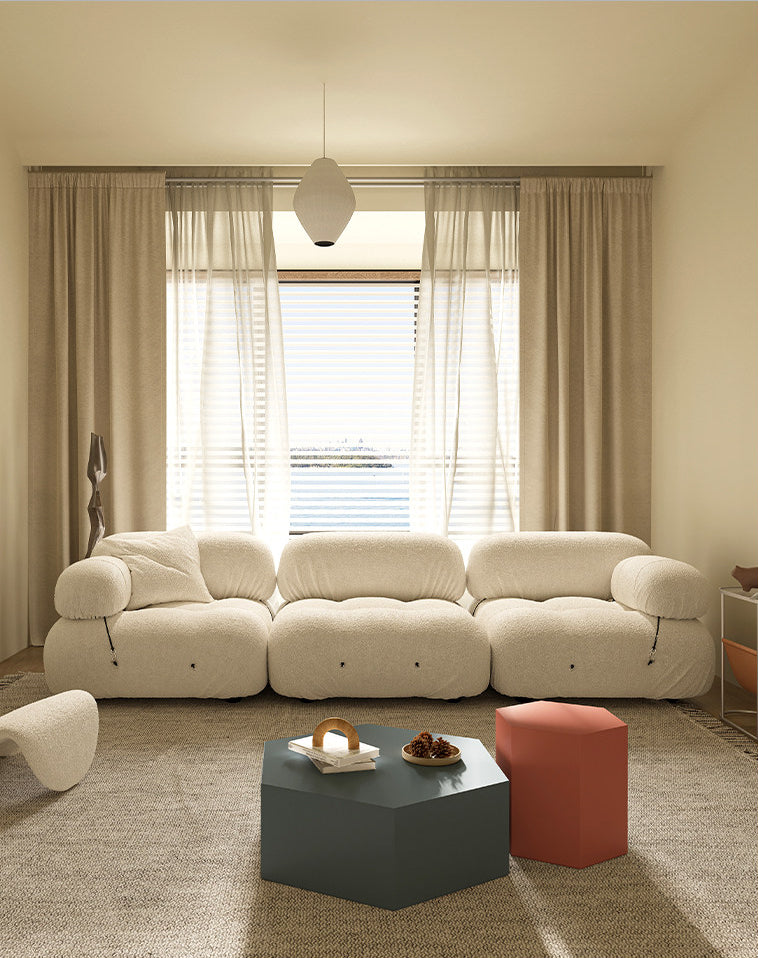 Cream modular sectional sofa with curved arms and segmented cushioned back