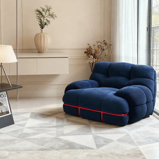 Hippopotamus sofa, ocean blue corded fabric with red trim piping and rounded lounge cushions