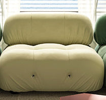 Light yellow sofa module with rounded armrest and tufted seat cushions