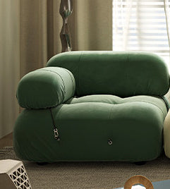 Green sofa module with rounded armrest and tufted seat cushions