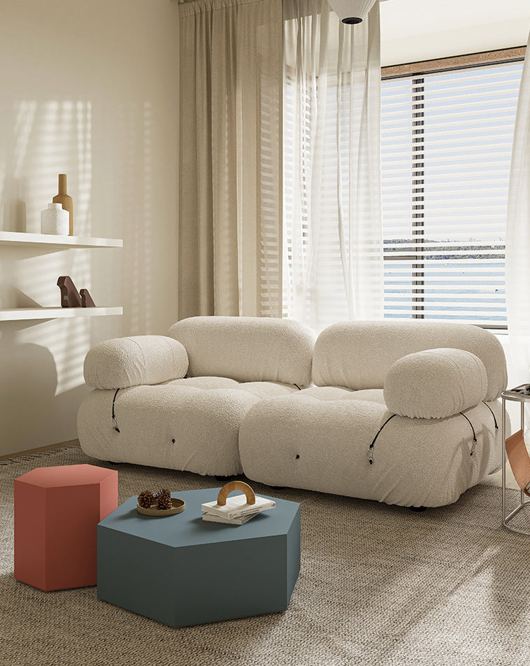 Cream modular sectional sofa with rounded armrests and three segmented seat cushions