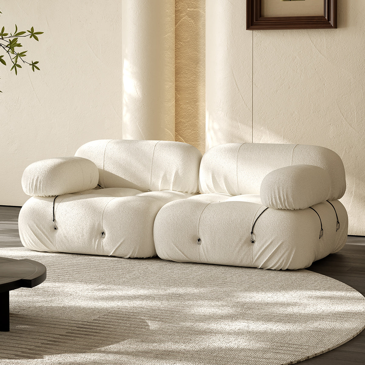 Two-seater compressed sofa with curved arms and tufted cushioning, light beige fabric