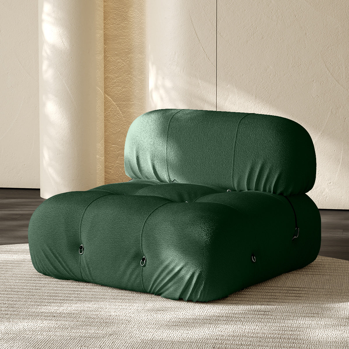 Armless single module sofa in dark green, tufted back and padded roll cushions.