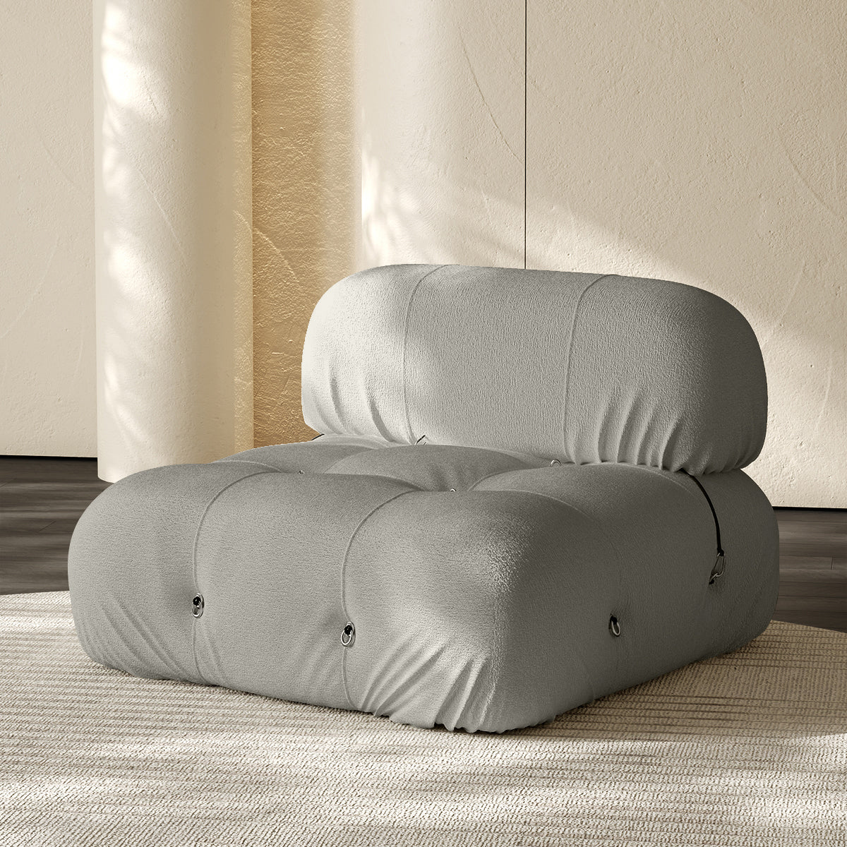 Light gray armless single-module compression sofa with rounded cushions, side buttons