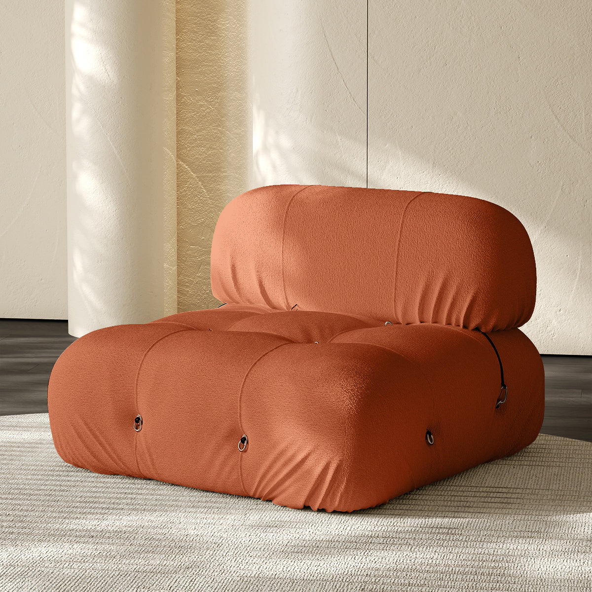 Armless single module sofa in orange, tufted back and padded roll cushions.
