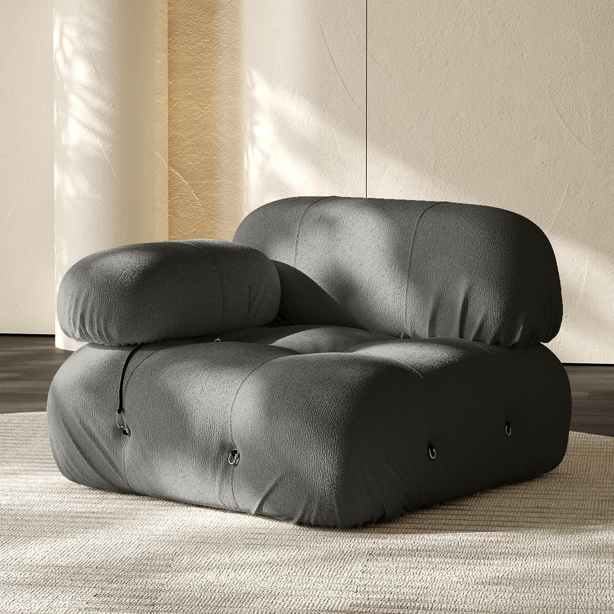 Gray sofa corner module with rounded backrest and seat, button-tufted details