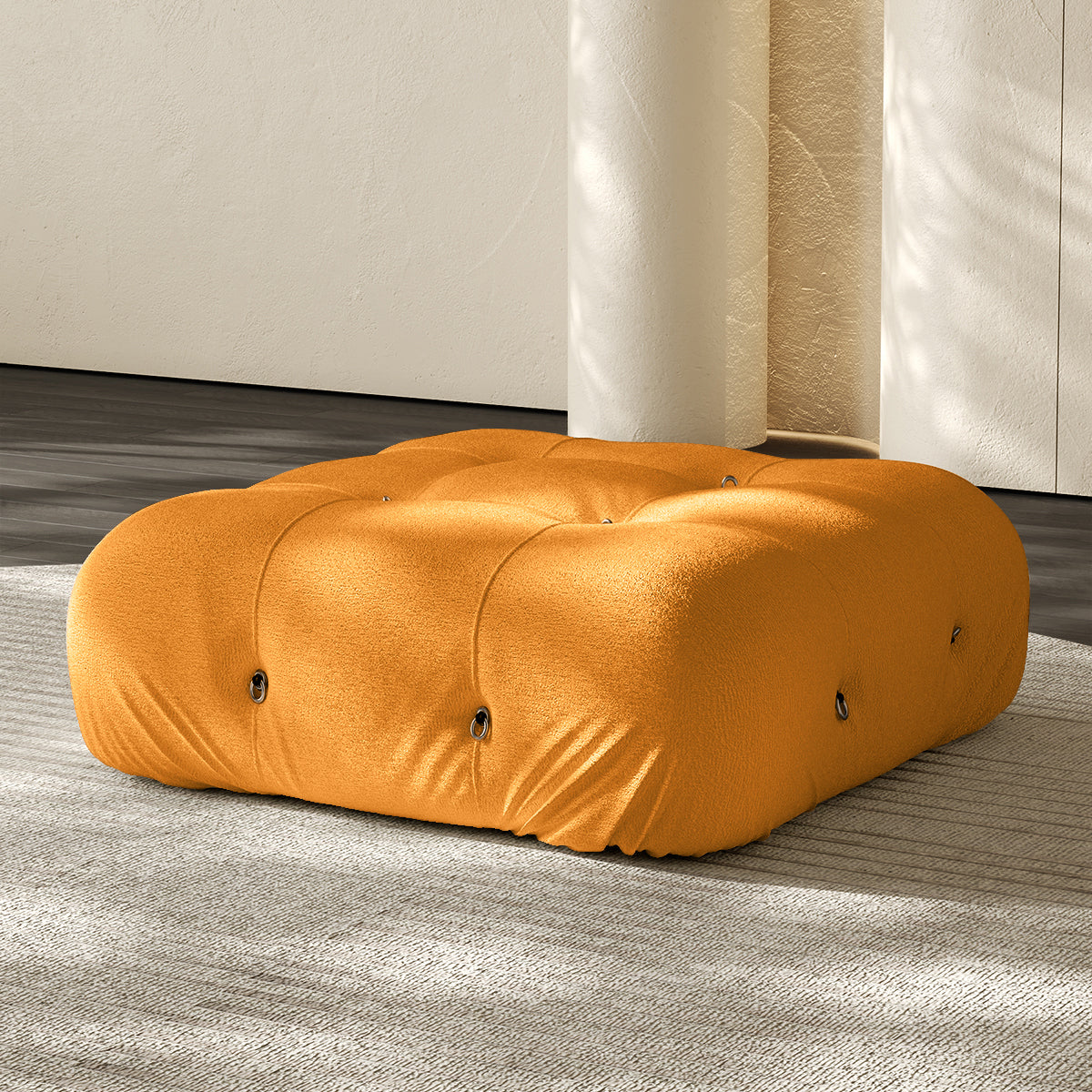 Orange compressed sofa ottoman with rounded fabric wrap and visible seams