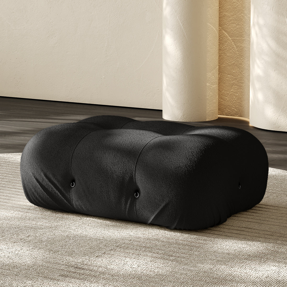Vacuum-packed rectangular ottoman, rolled upholstered cushion in black.