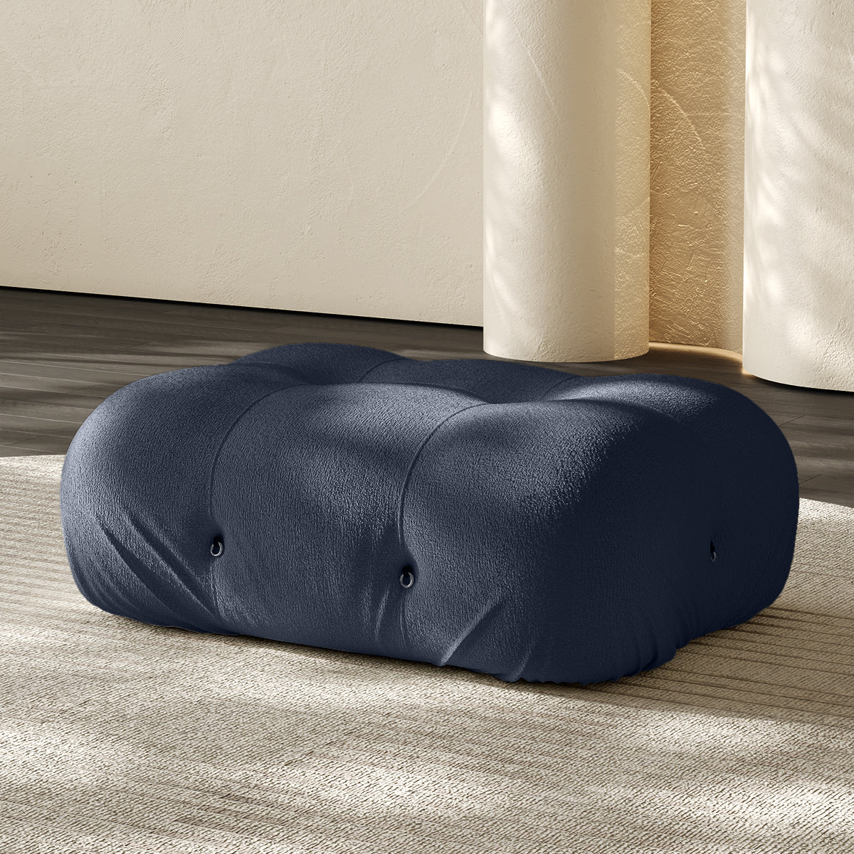 Vacuum-packed rectangular ottoman, rolled upholstered cushion in blue.