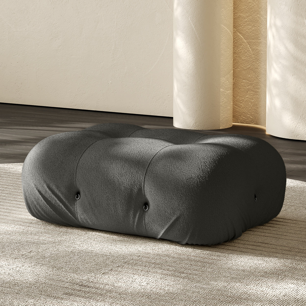Vacuum-packed rectangular ottoman, rolled upholstered cushion in dark gray.