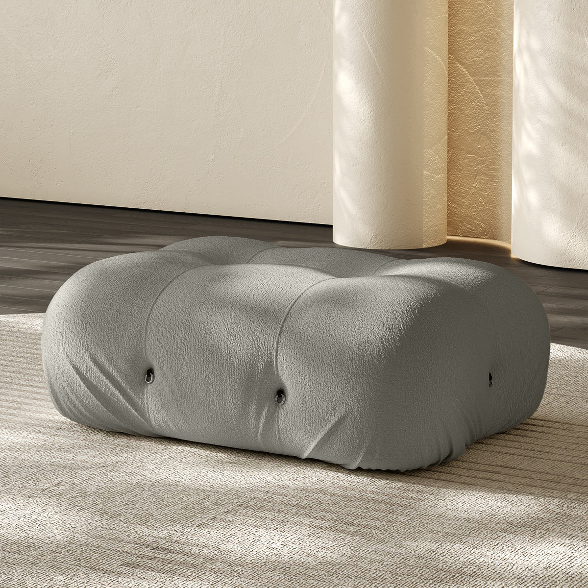 Vacuum-packed rectangular ottoman, rolled upholstered cushion in light gray.