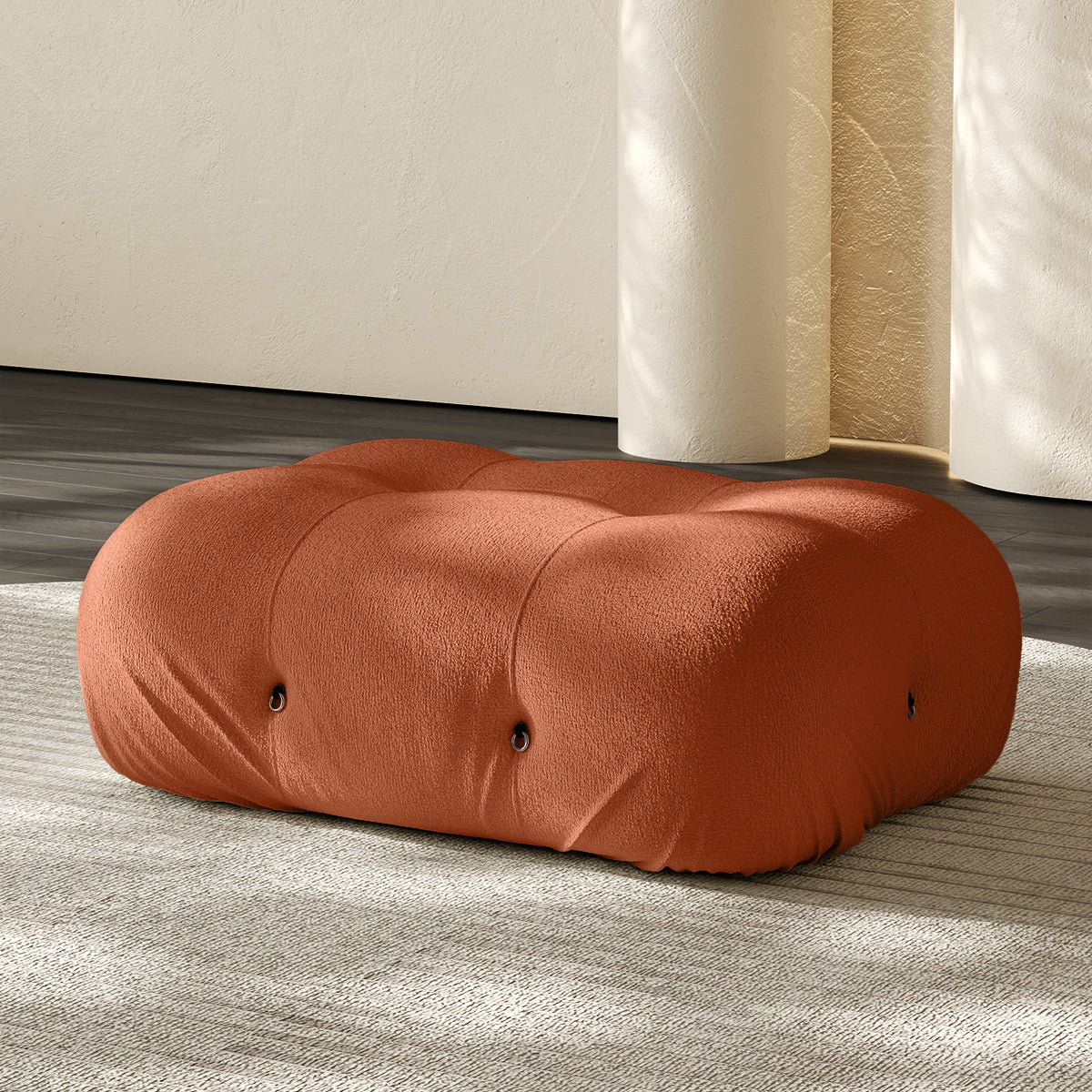 Vacuum-packed rectangular ottoman, rolled upholstered cushion in orange.