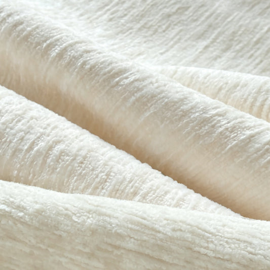 Light beige vacuum-packed compression sofa upholstery fabric close-up texture