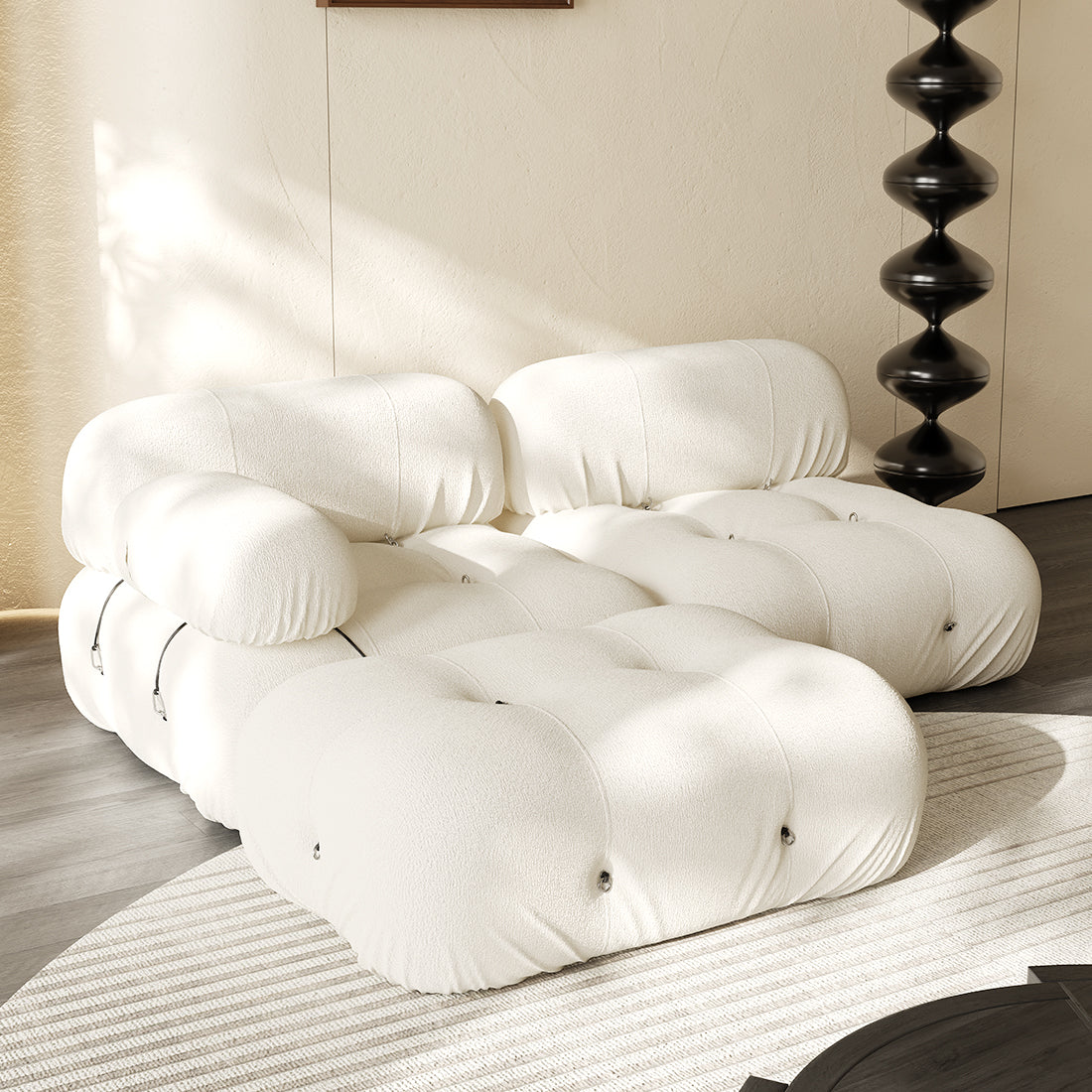 Hiksnra three-piece sectional sofa in ivory, viewed from above to show its deep tufted seats