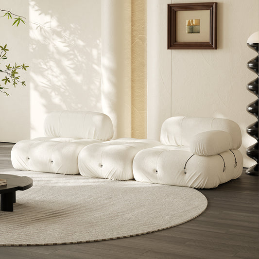 Hiksnra three-piece sectional sofa in ivory, arranged in a low, wide configuration