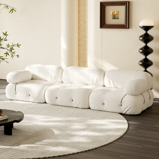 Hiksnra three-seat floor sofa in off-white fabric with plush segmented cushions