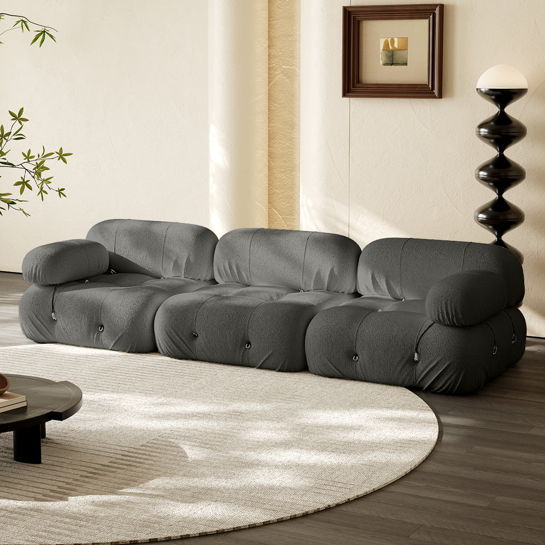 3-seater straight sofa in dark gray fabric with tufted cushions and rolled arms.