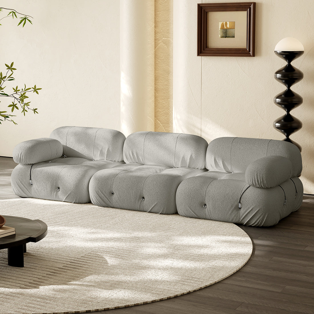 3-seater straight sofa in light gray fabric with tufted cushions and rolled arms.
