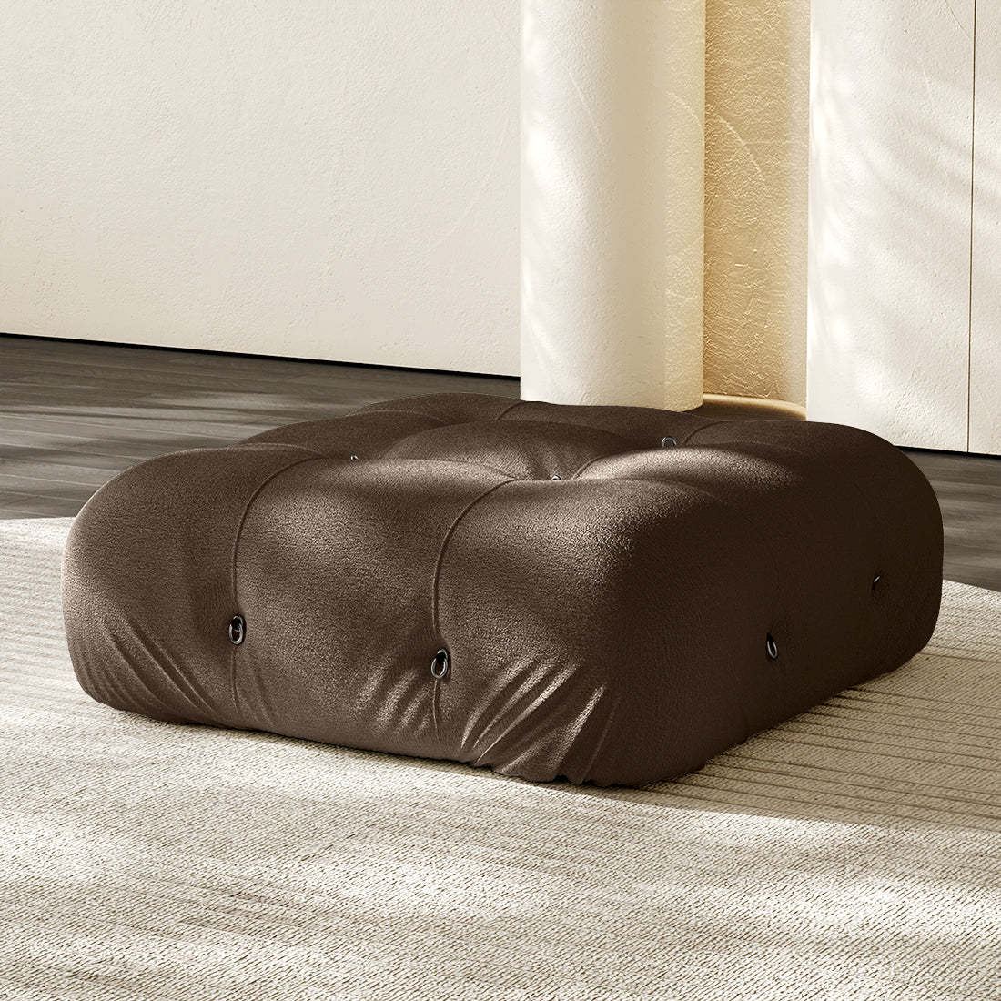 Dark brown square ottoman with tufted button details and plush compression cushioning.