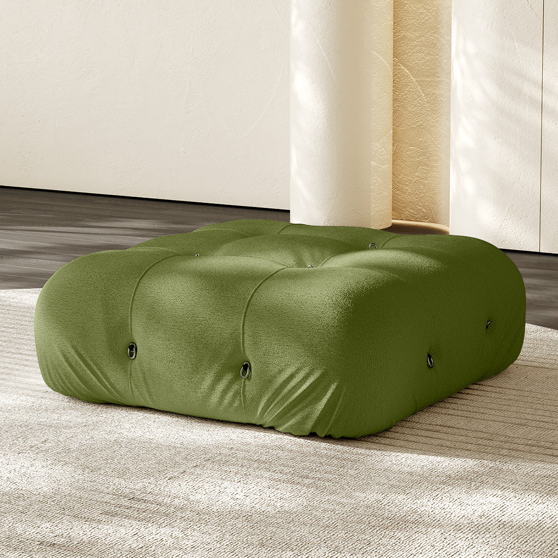 Green square ottoman with tufted button details and plush compression cushioning.