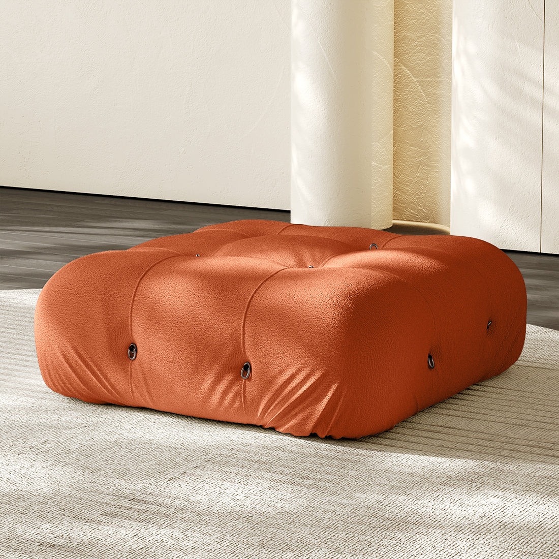 Orange square ottoman with tufted top and padded fabric cover