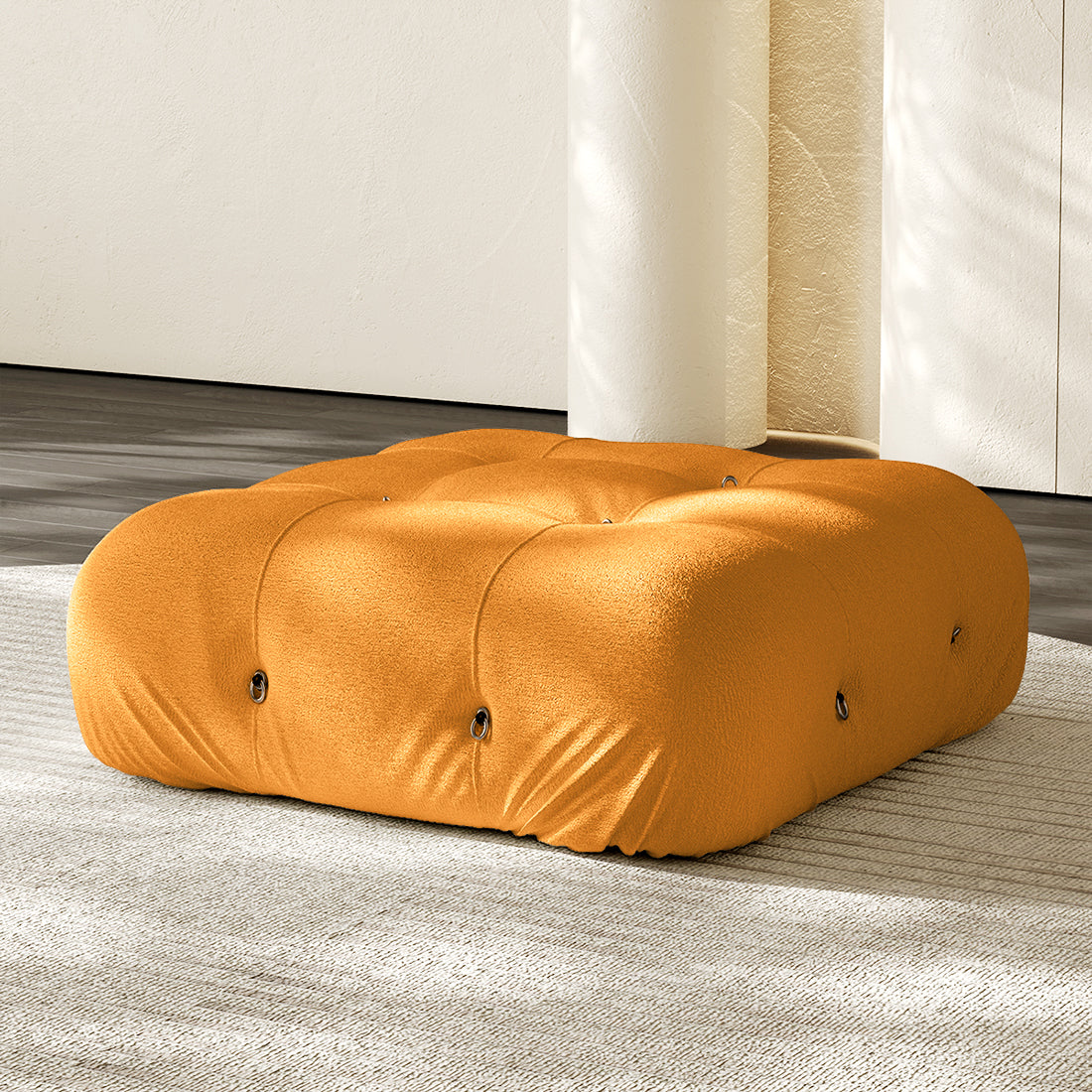 Orange square ottoman with tufted button details and plush compression cushioning.