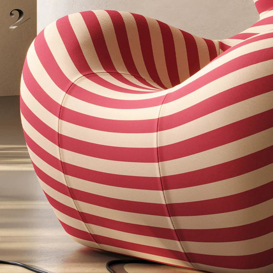 Hiksnra La Mamma UP5_6 lounge chair in red and beige striped upholstery, showing its sculptural curves and wraparound seat for enveloping comfort.