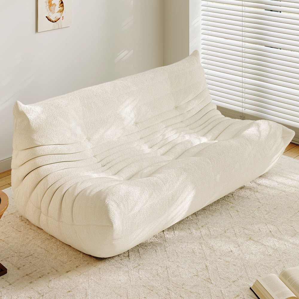 3-seater sofa bed in beige, tufted back and ribbed padded seat with curved arms