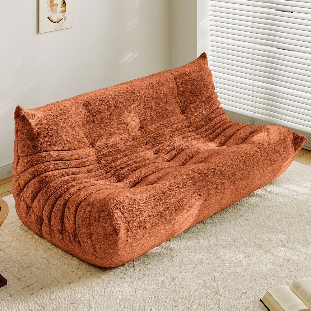3-seater sofa bed in orange, tufted back and ribbed padded seat with curved arms