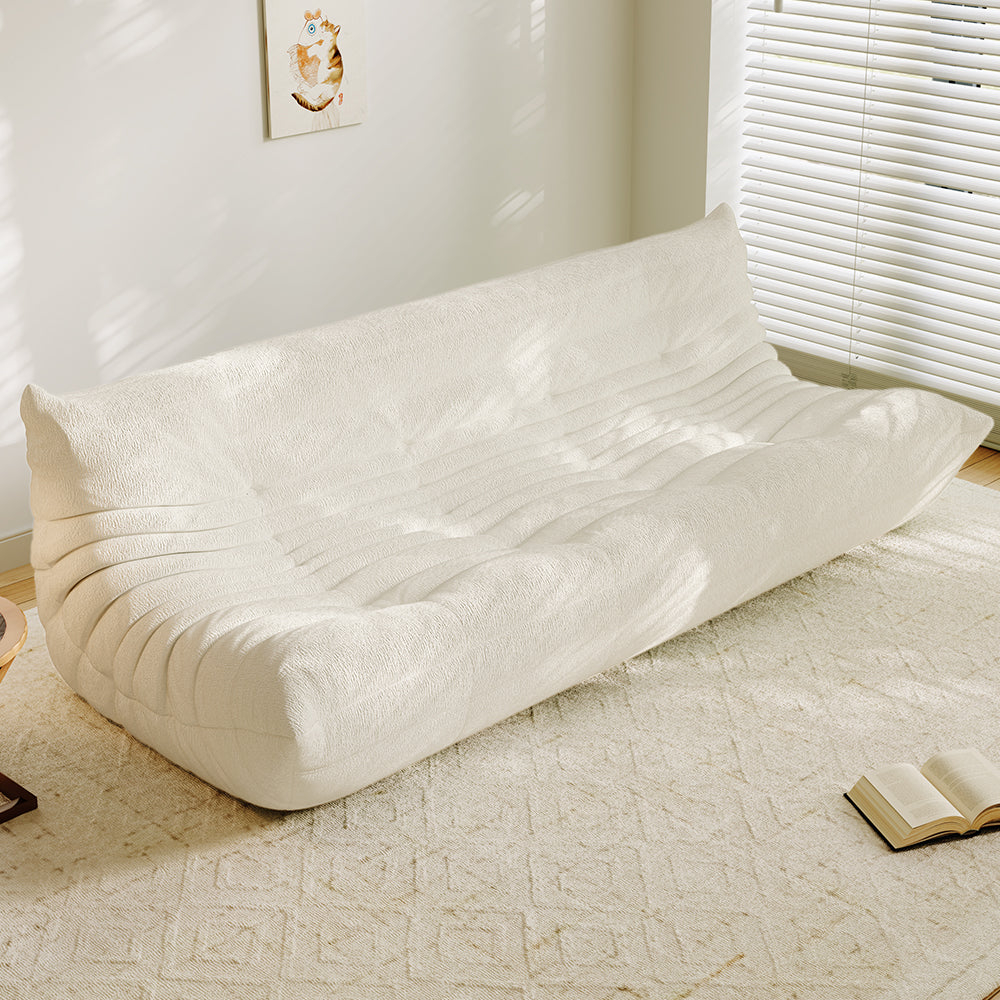 4-seater vacuum-packed sofa in beige, tufted cushions with ribbed backrest.
