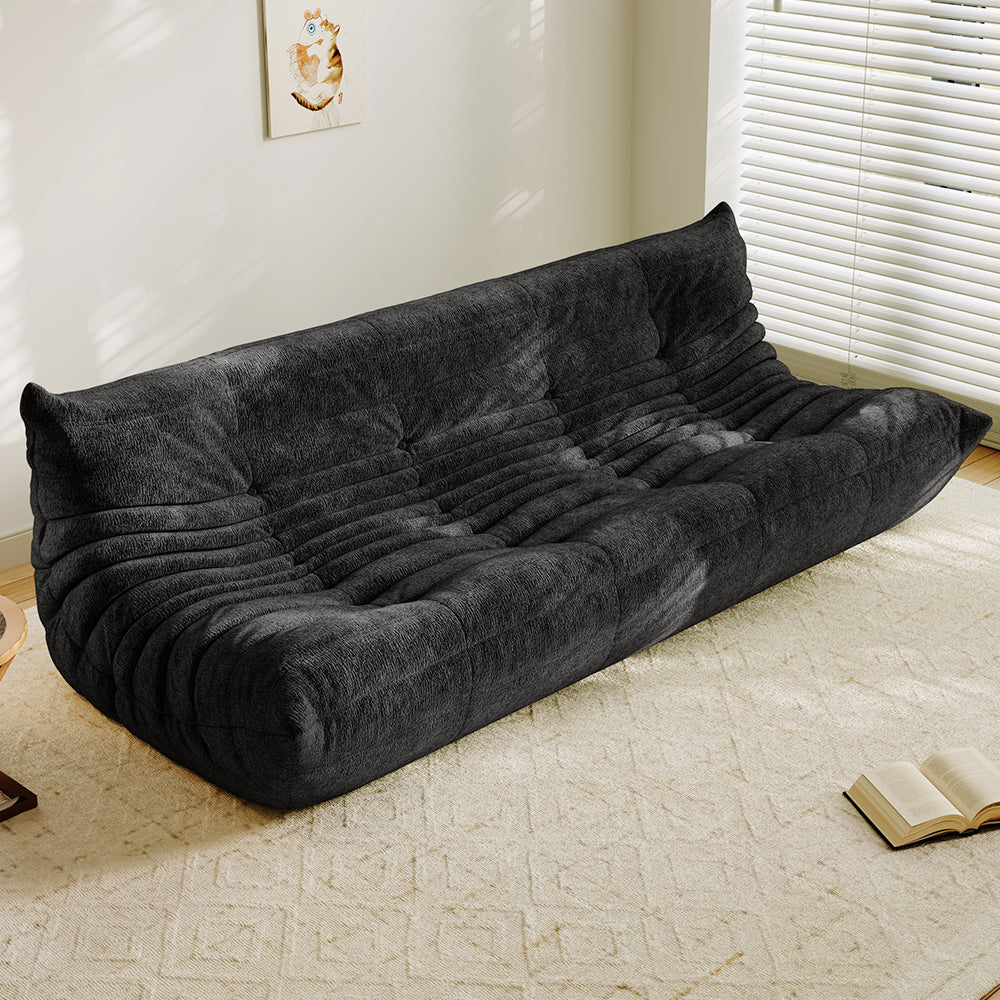 4-seater vacuum-packed sofa in dark gray, tufted cushions and ribbed backrest.