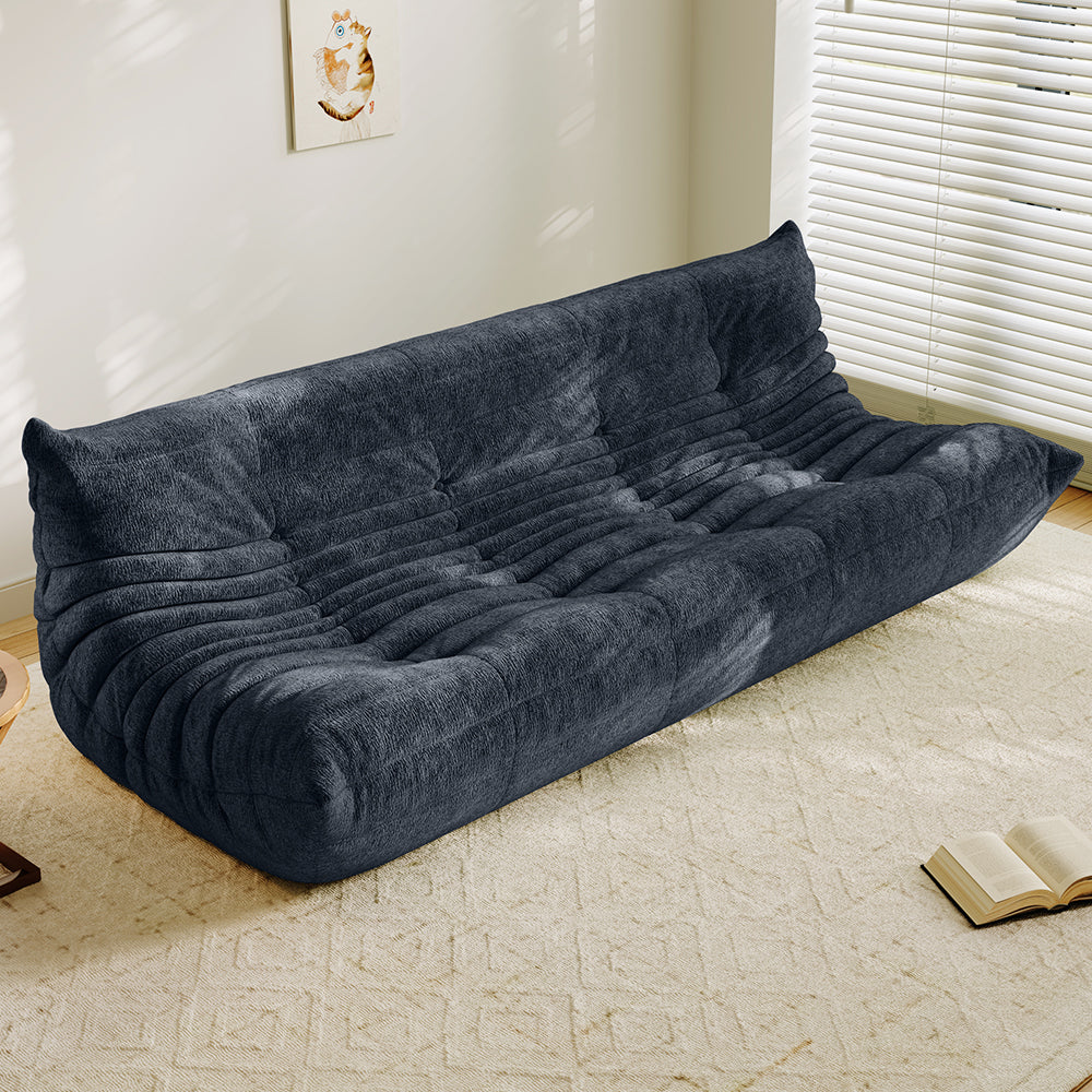 4-seater vacuum-packed sofa in dark gray, tufted cushions and ribbed backrest.