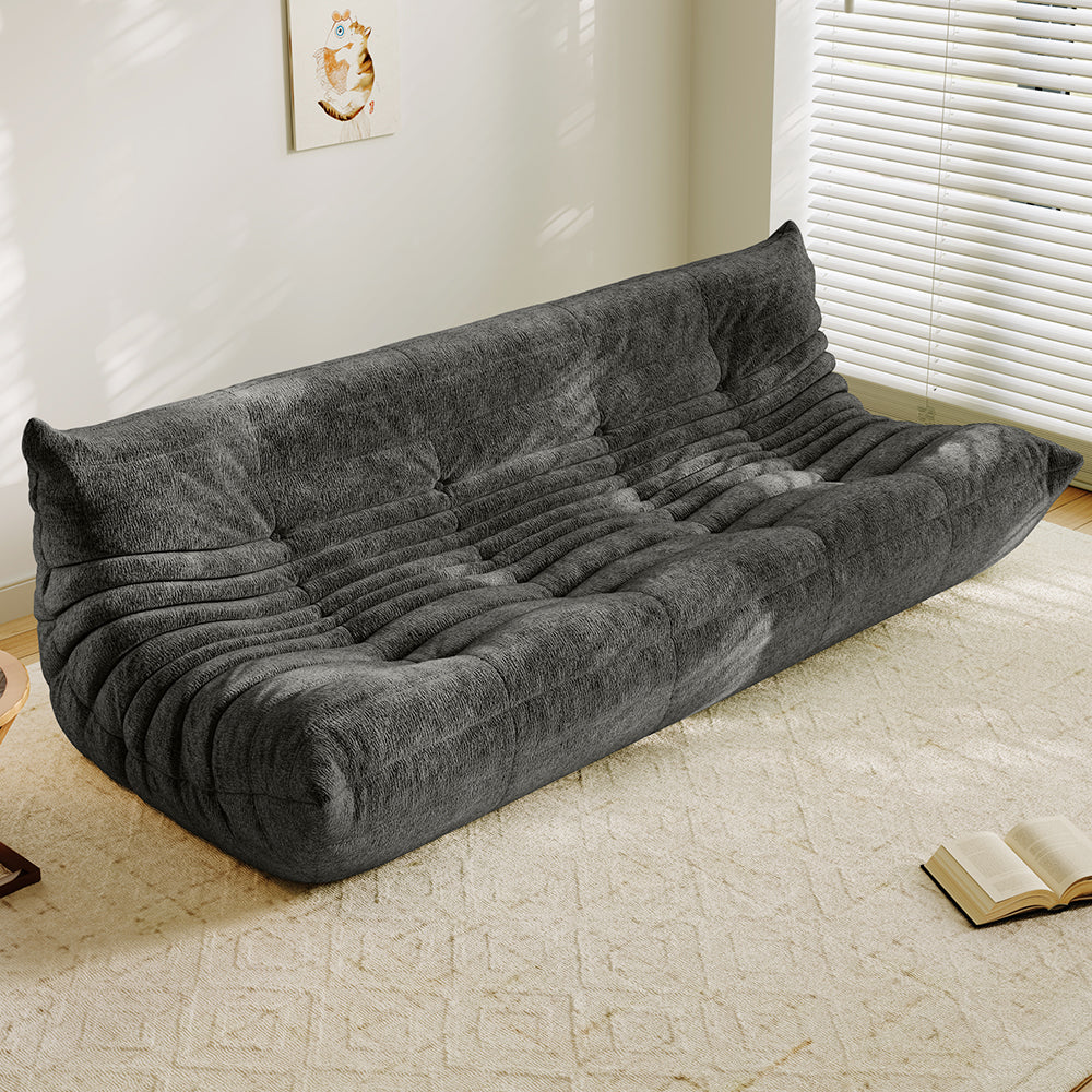 4-seater vacuum-packed sofa in gray, tufted cushions with ribbed backrest.