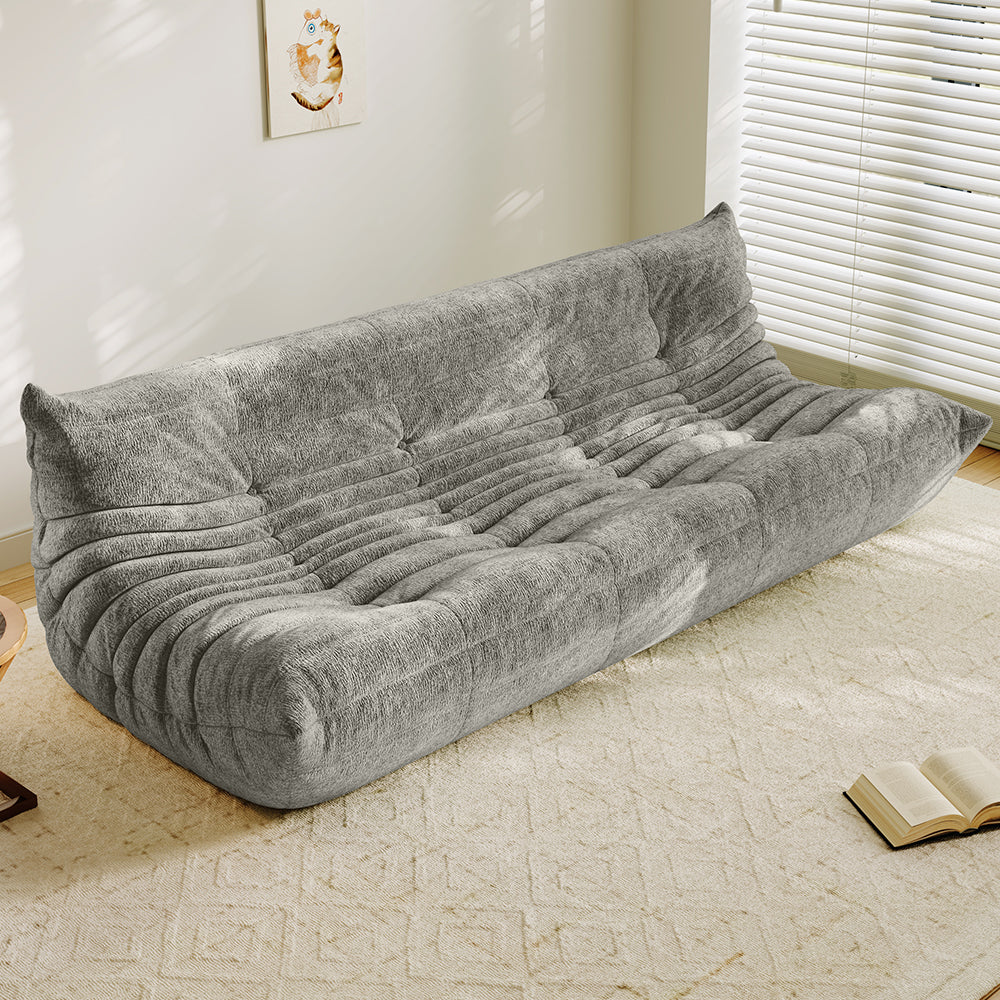 4-seater vacuum-packed sofa in medium gray, tufted cushions and ribbed backrest.