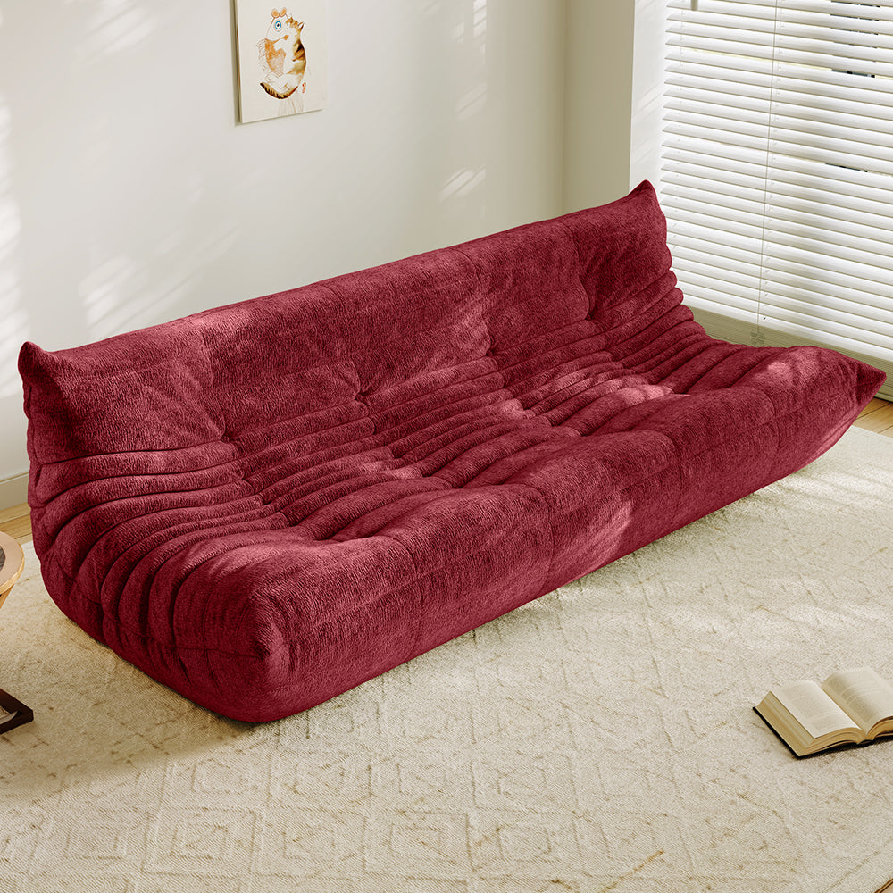 4-seater vacuum-packed sofa in red, tufted cushions and ribbed backrest.