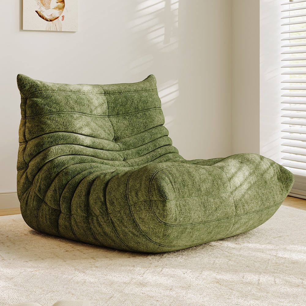 Olive green lounge sofa chair with cushioned backrest and curved seat with quilted wave lines.