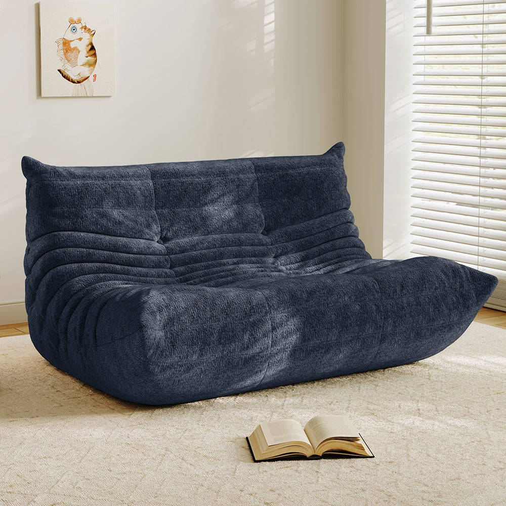 Navy velvet-look loveseat sofa with tufted back and curved chaise seat