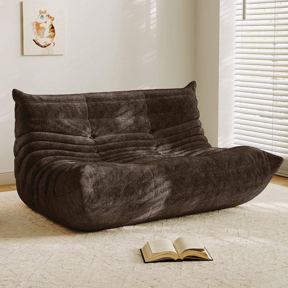 Brown velvet-look loveseat sofa with tufted back and curved chaise seat