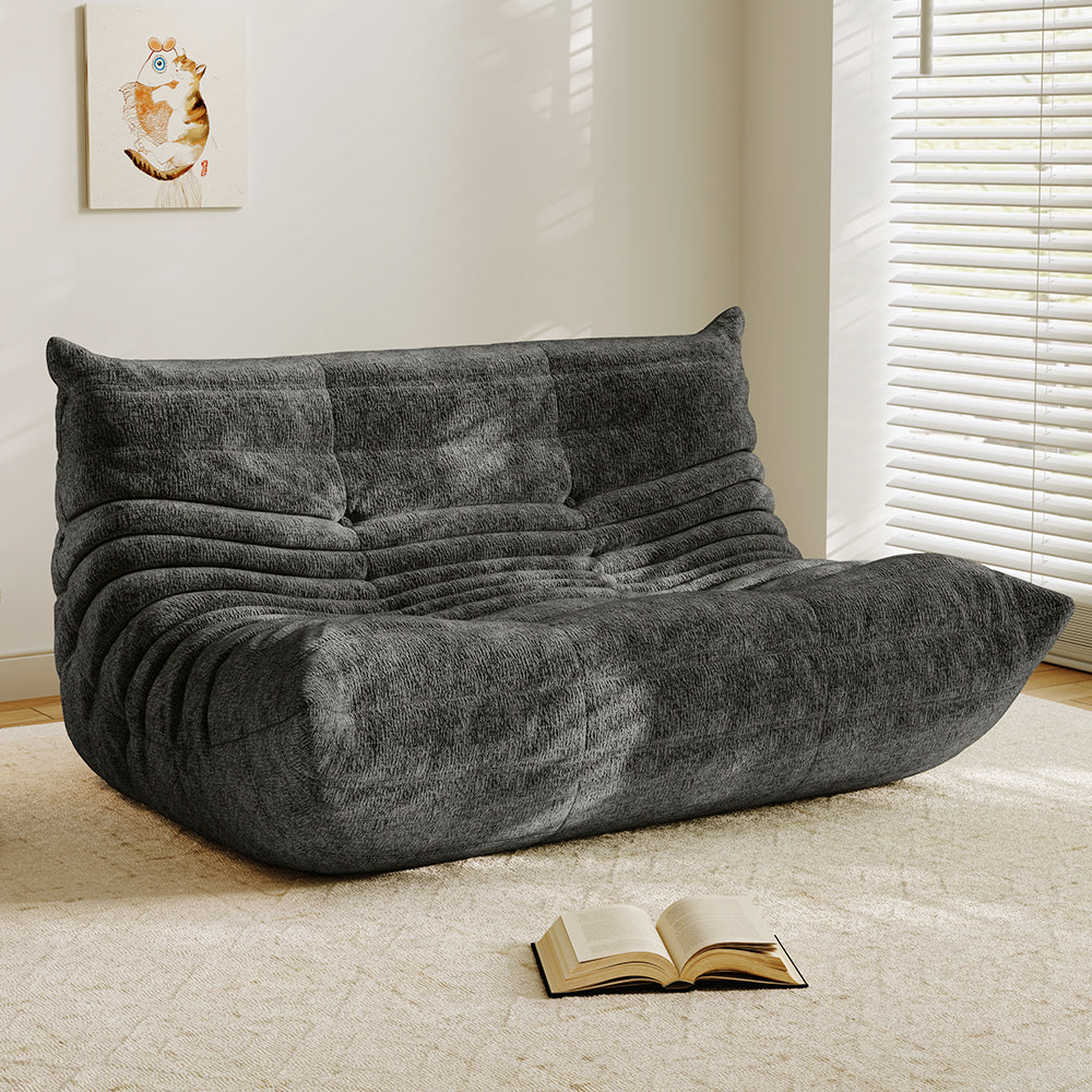 Charcoal velvet-look loveseat sofa with tufted back and curved chaise seat