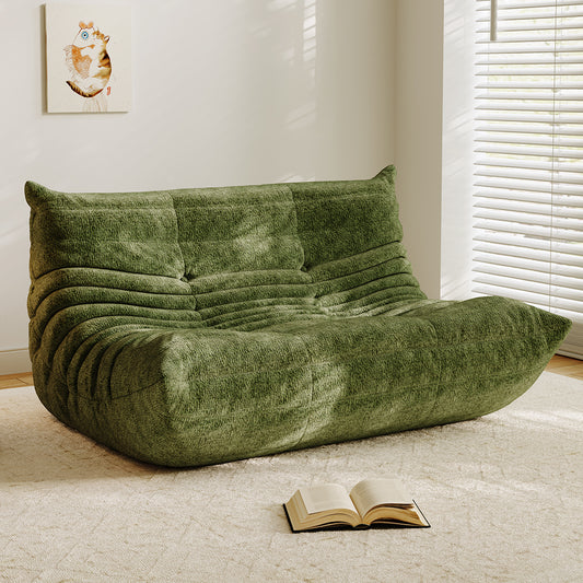 Grass green velvet-look loveseat sofa with tufted back and curved chaise seat