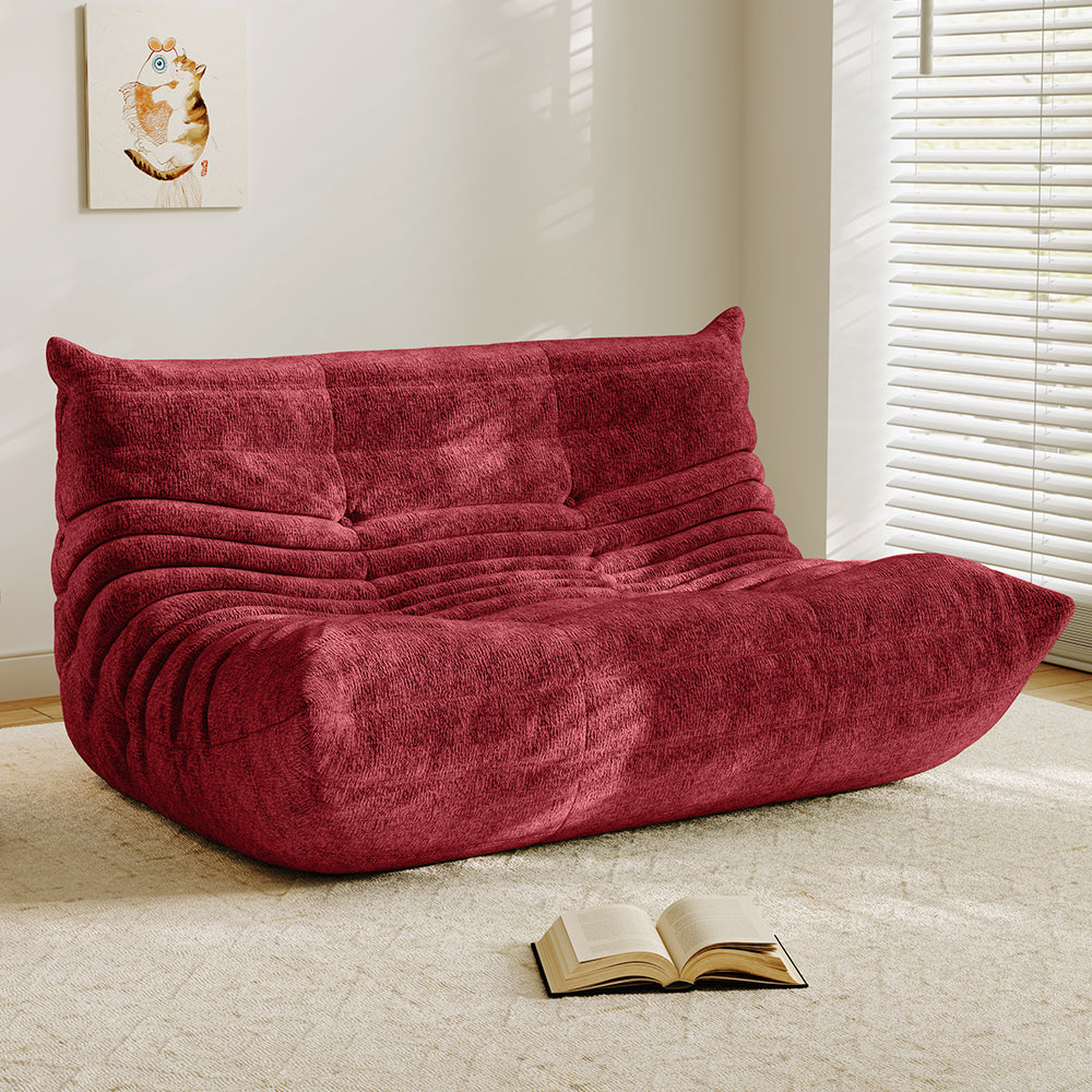 Red velvet-look loveseat sofa with tufted back and curved chaise seat